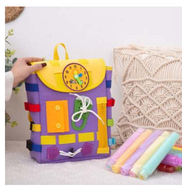 Colorful children's backpack with a clock design on a light background.