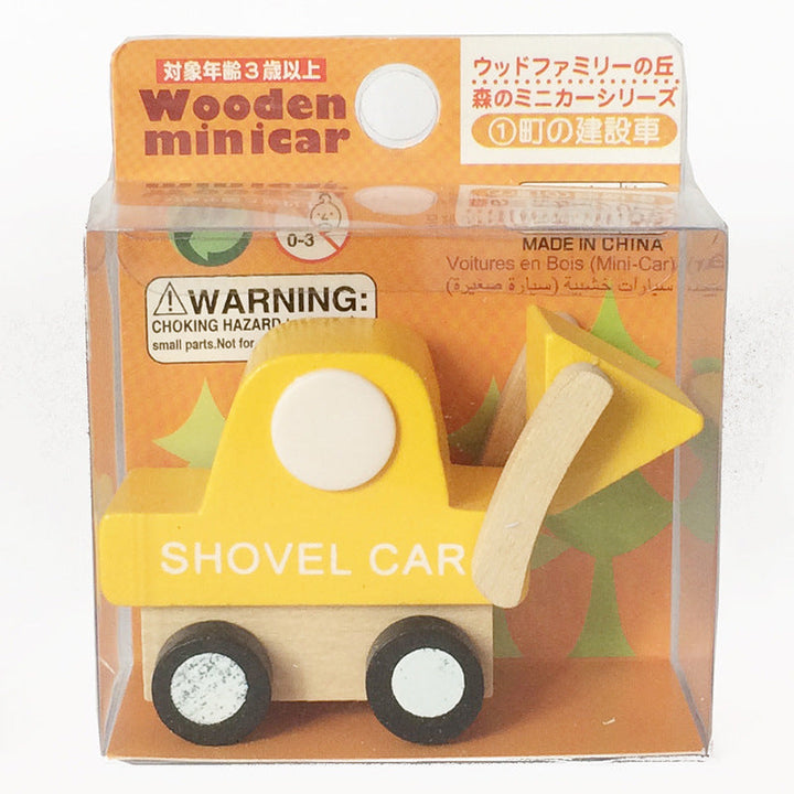 Wooden toy shovel car in packaging with warning label.