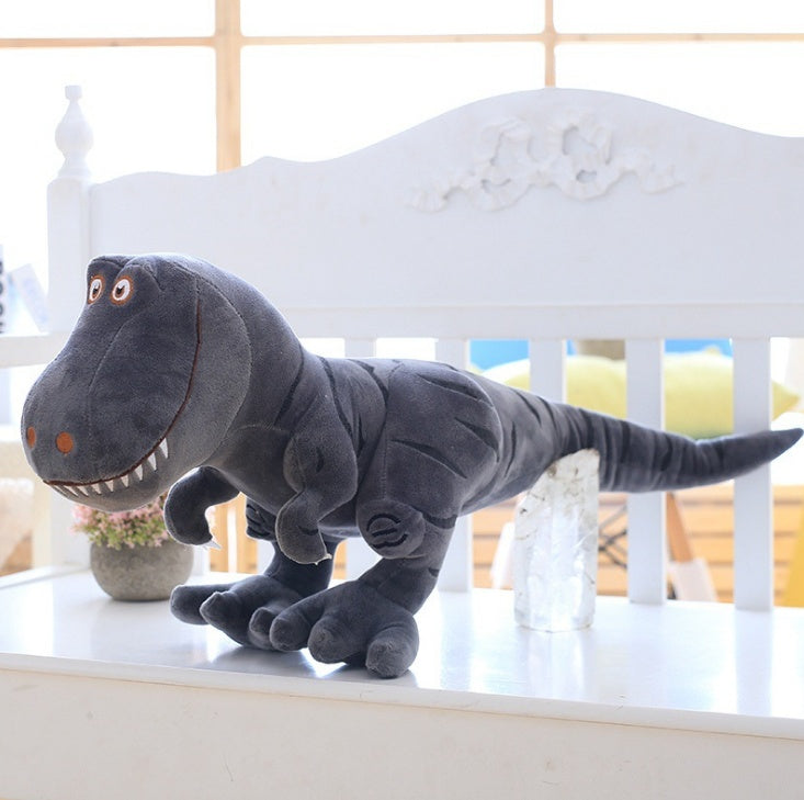 Gray dinosaur plush toy on a white surface with a blurred background.