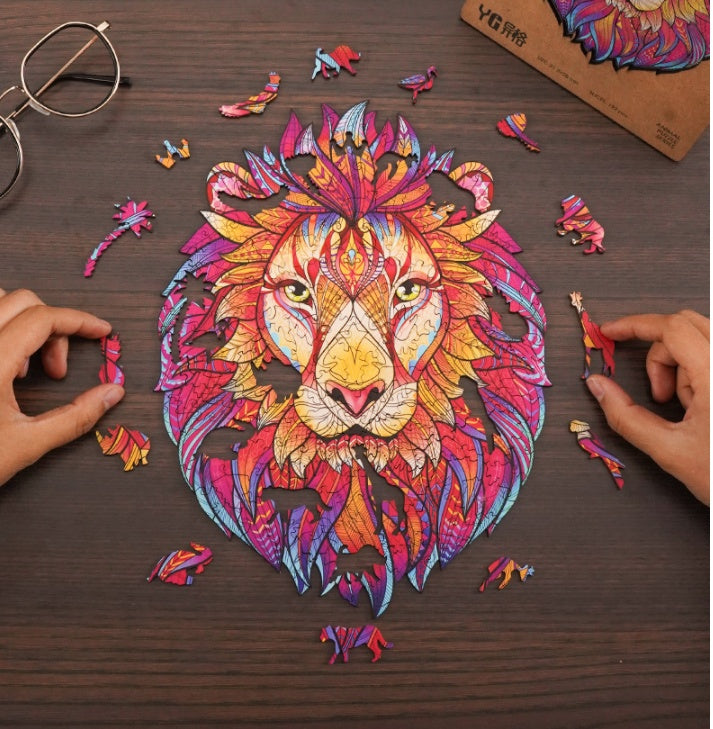 Colorful lion puzzle being assembled on a wooden table with hands and puzzle pieces visible.