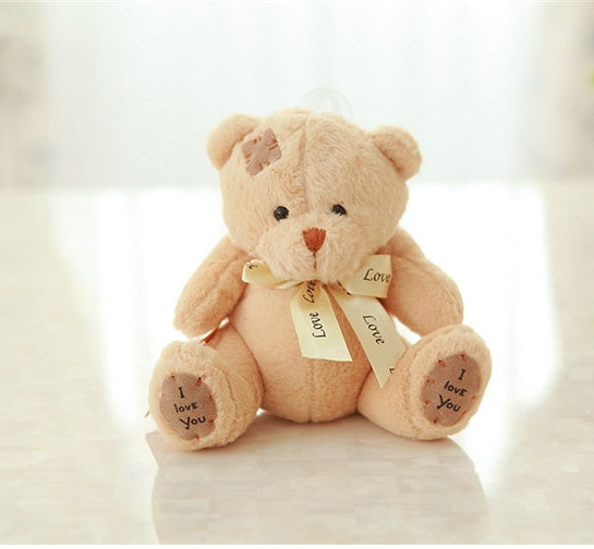 Cute teddy bear with 'I love you' tags on a light background.