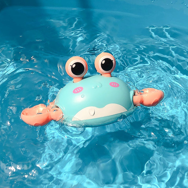 Toy crab floating in clear blue water.