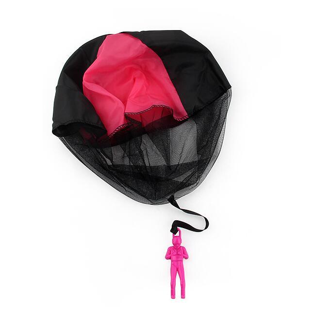 Black and pink parachute with a small pink figure hanging from it on a white background.