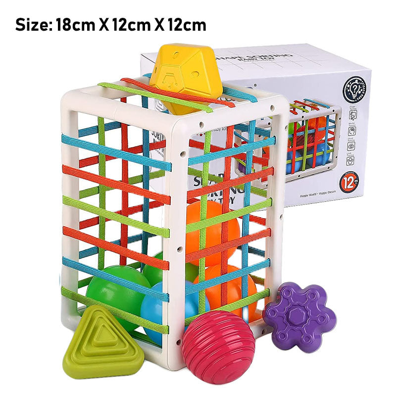 Colorful children's toy with geometric shapes and a box in the background.