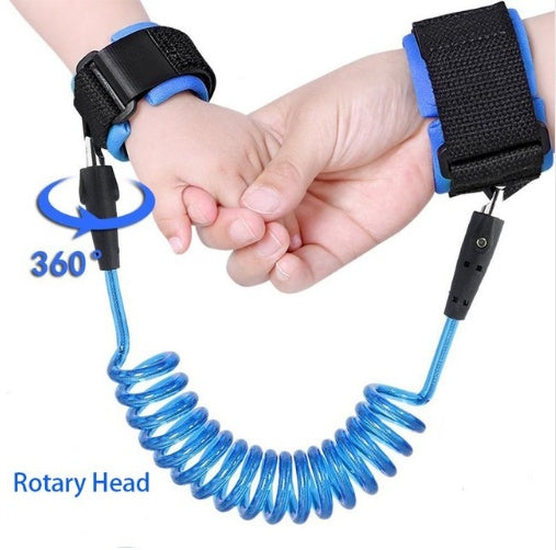 Child's hand holding a blue anti-lost wrist strap with a black buckle.