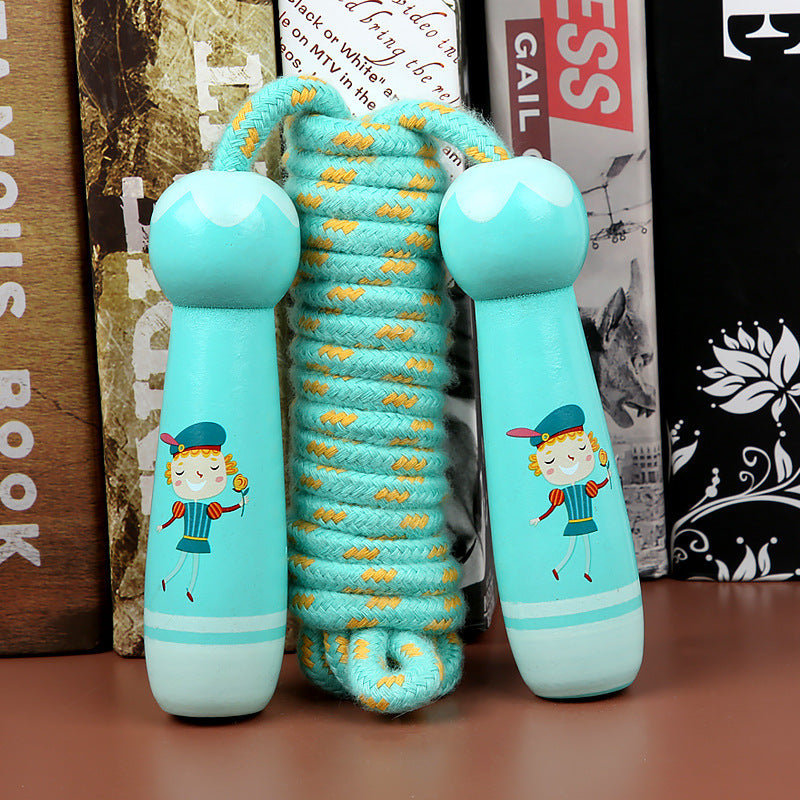 Children's jump rope with cartoon character handles on a wooden surface.