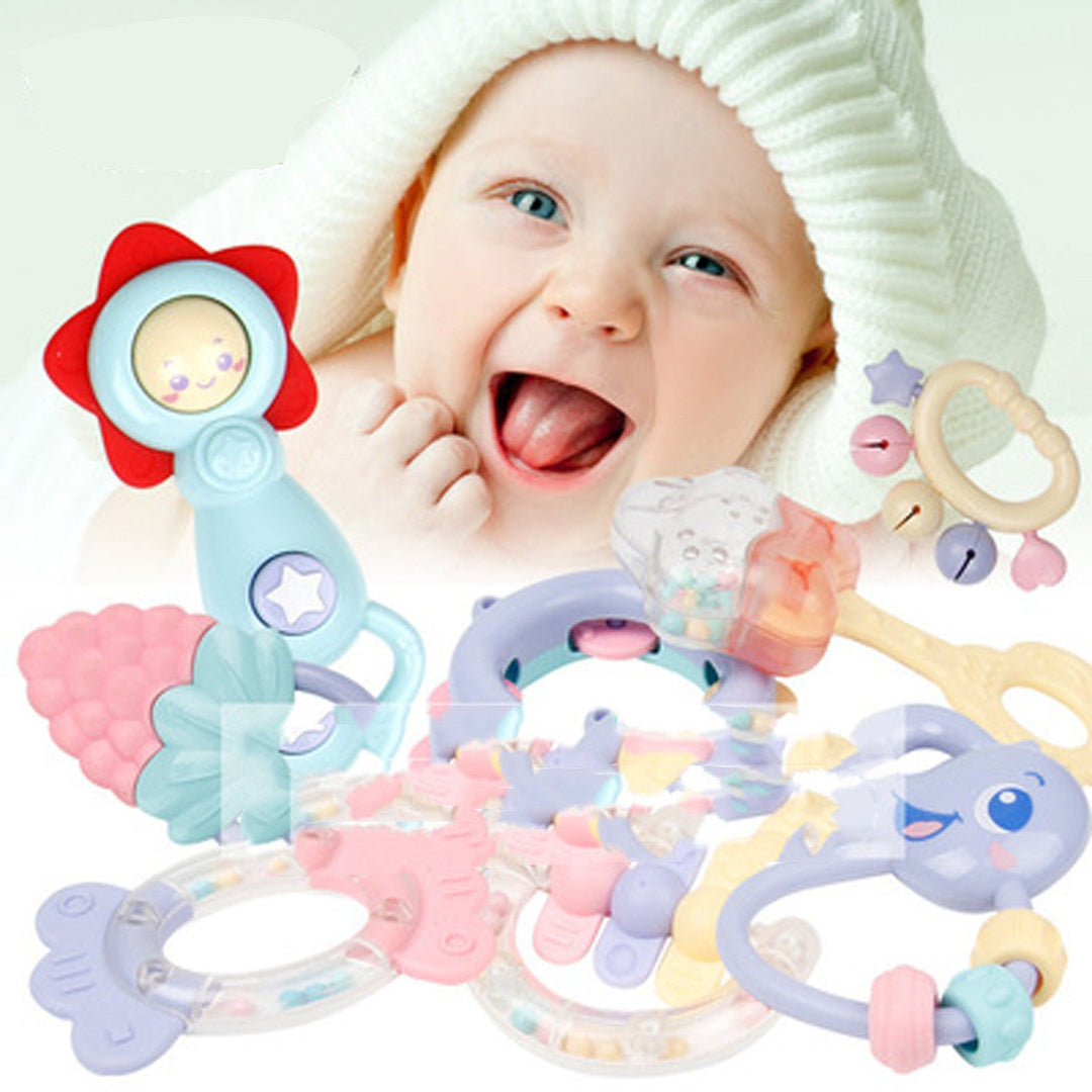 Baby with colorful rattles and toys on a white background.