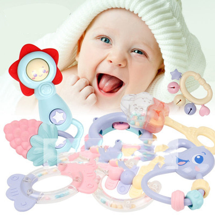 Baby with colorful rattles and toys on a white background.