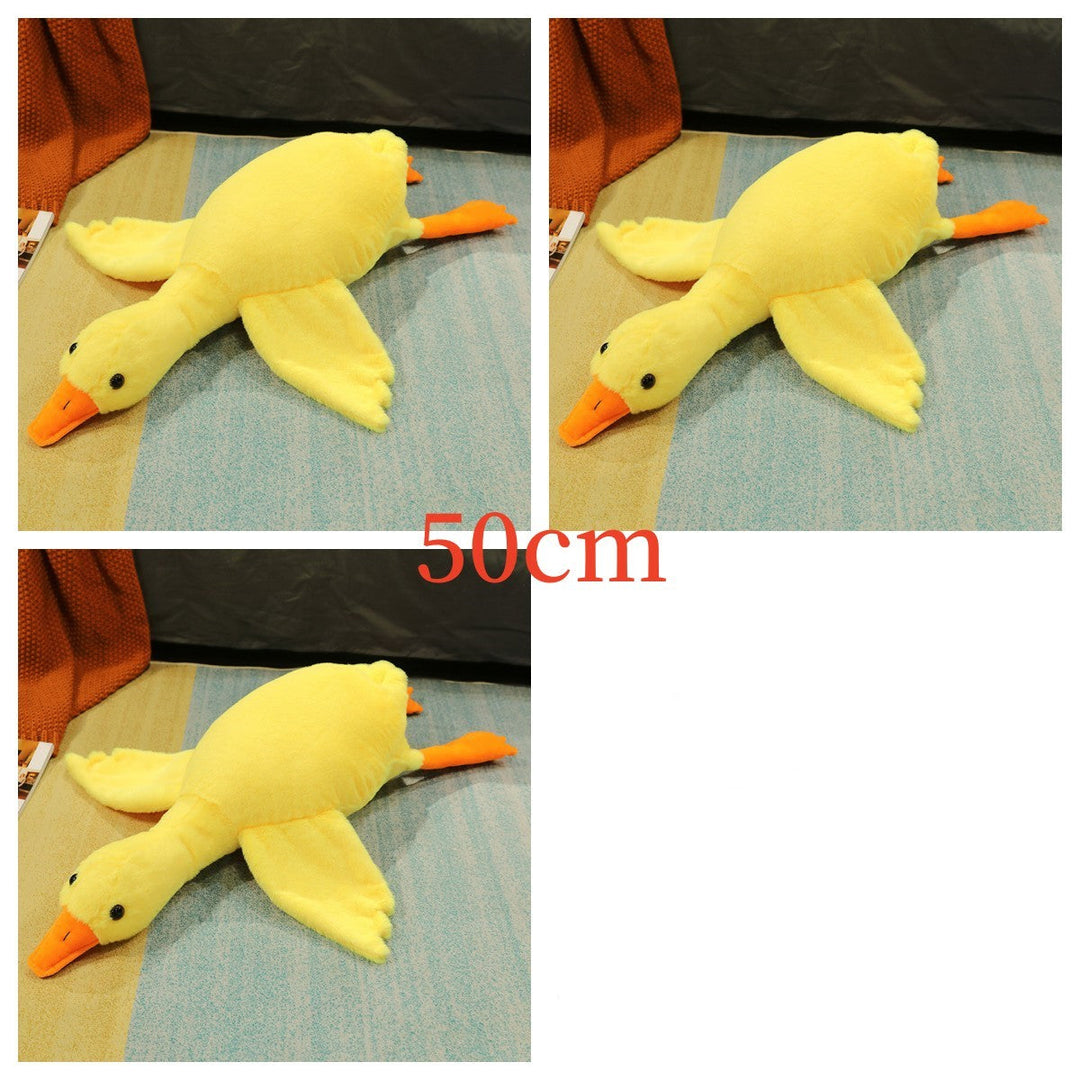 Yellow plush duck toy on a blue surface.