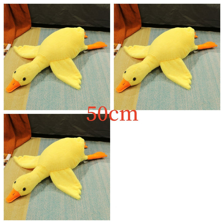 Yellow plush duck toy on a blue surface.