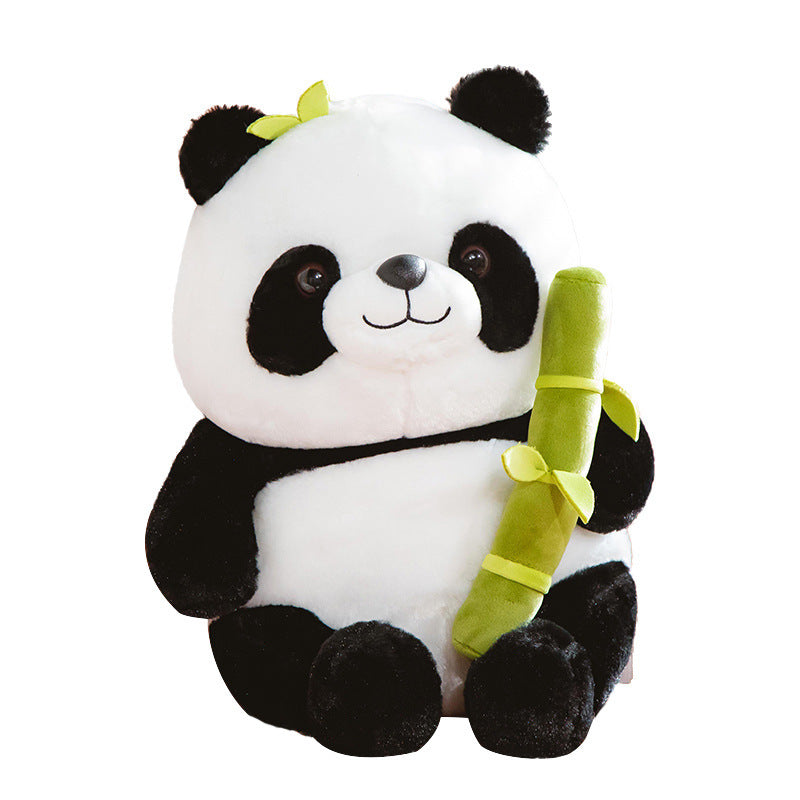 Plush panda toy holding a bamboo stick on a white background.