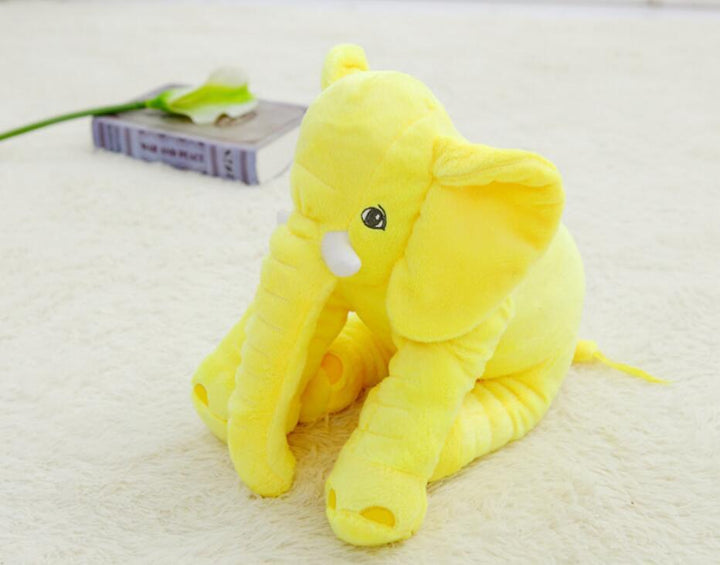 Yellow elephant plush toy on a light-colored surface.