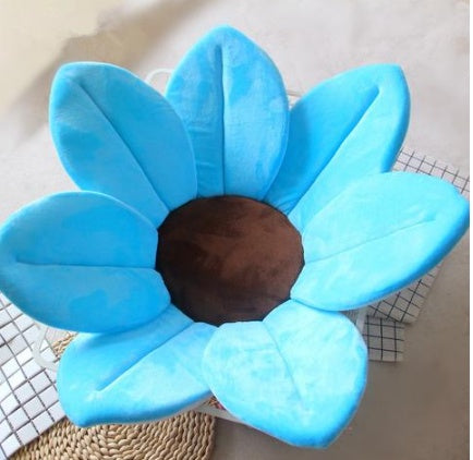 Blue flower-shaped cushion on a checkered background.