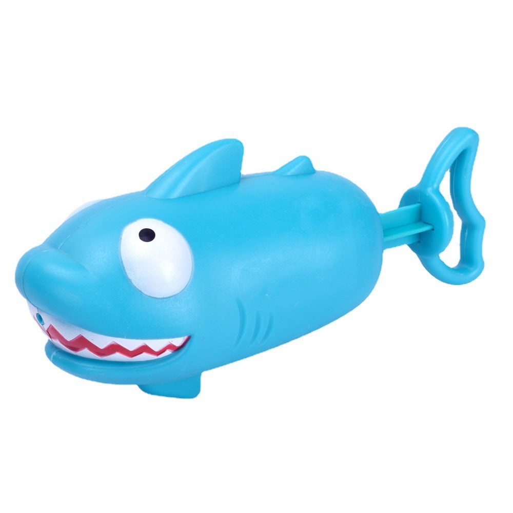 Blue toy shark with a handle on a white background.