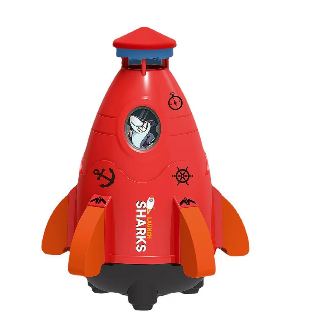 Red toy rocket with shark design on a white background.