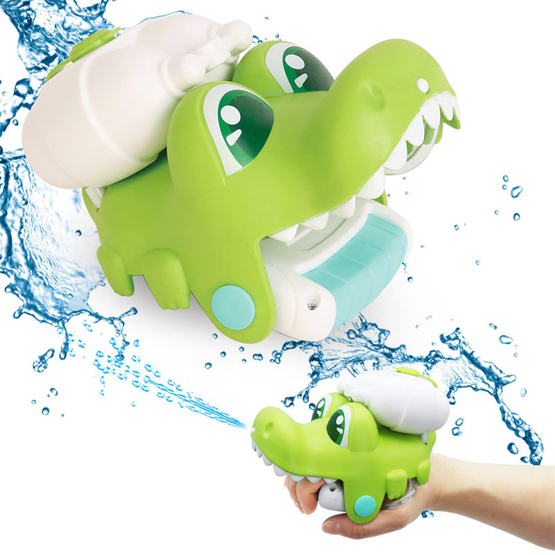 Green dinosaur-shaped bath toy with water splashes on a white background.