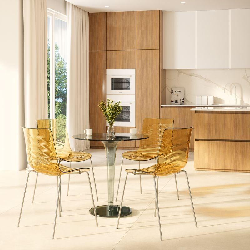 LeisureMod Astor Water Ripple Design Dining Chair Transparent Orange at Table.