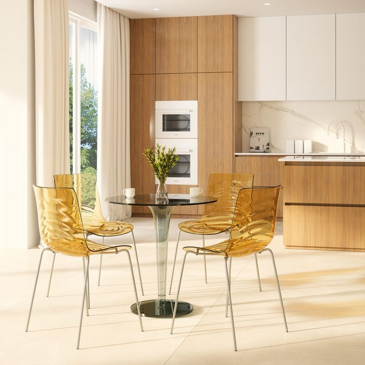 LeisureMod Astor Water Ripple Design Dining Chair Transparent Orange at Table.