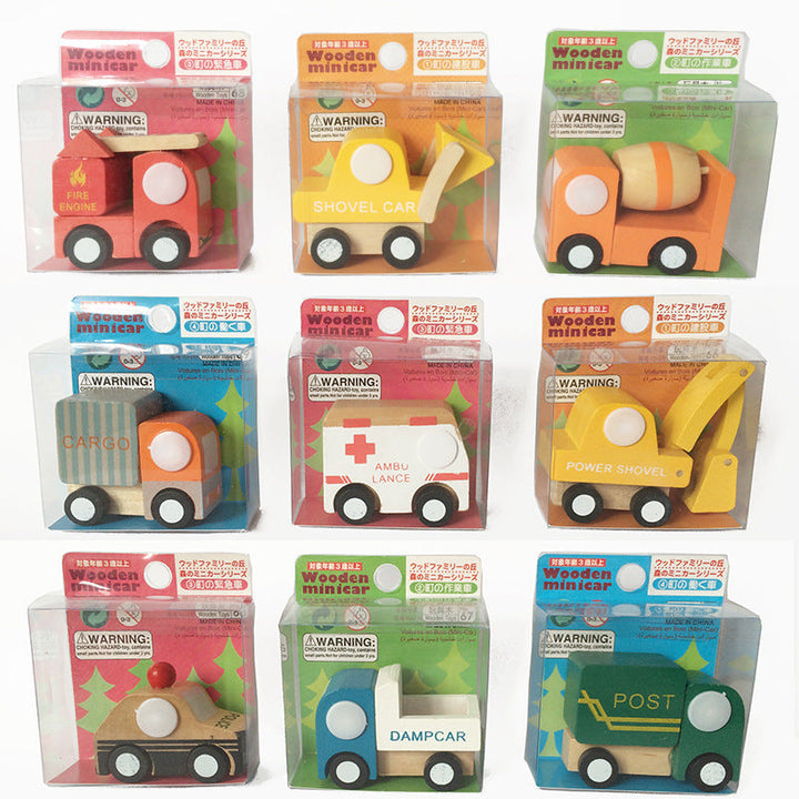 Set of wooden toy cars in packaging on a white background.