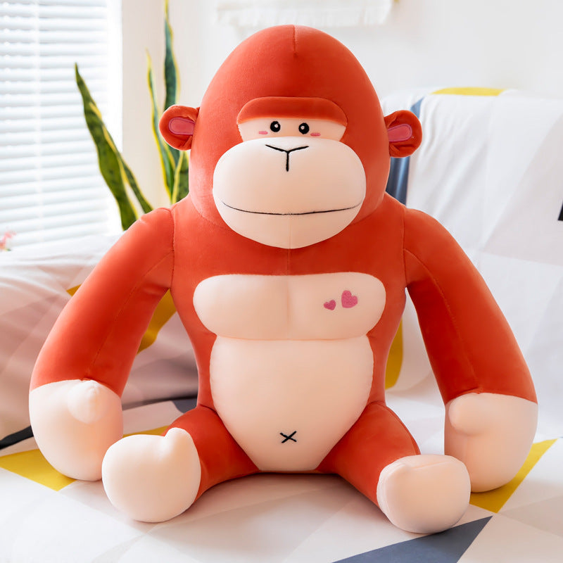 Plush monkey toy with a heart and cross symbol on a light background.