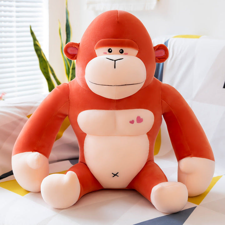 Plush monkey toy with a heart and cross symbol on a light background.