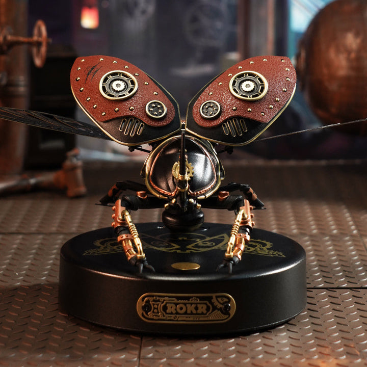 Steampunk-style mechanical insect model on a metallic surface.