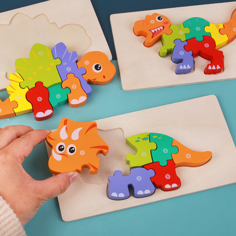 Colorful dinosaur-shaped puzzle pieces on a blue surface with a hand interacting with one of them.