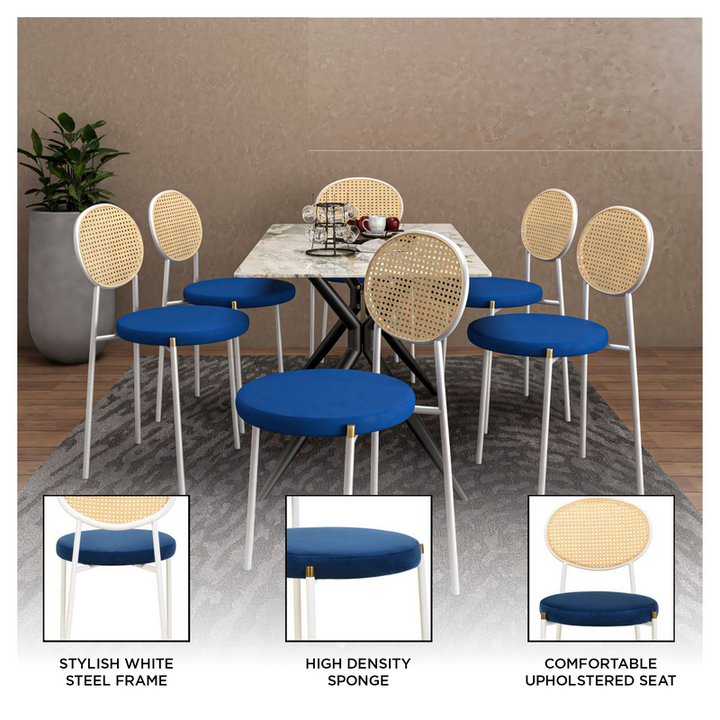 Dining table set with chairs featuring blue seats and white frames in a room setting.