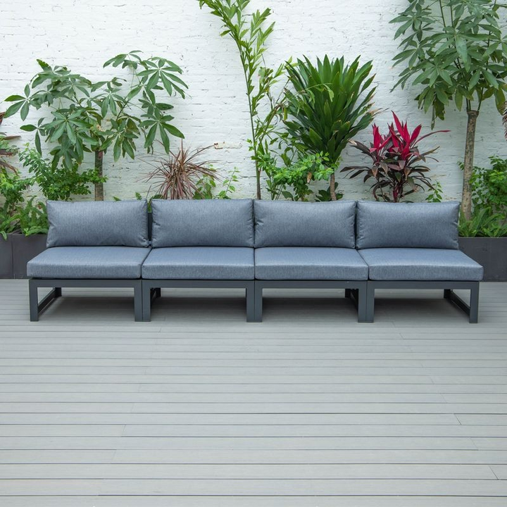 LeisureMod Chelsea 4-Piece Middle Patio Chairs Black Aluminum with Cushions Blue in a Row.