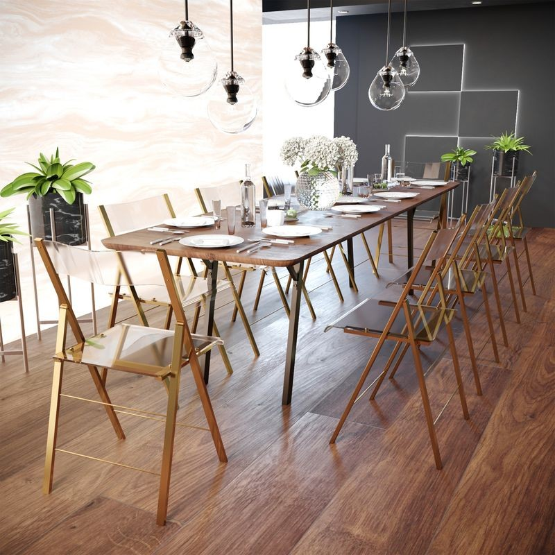 LeisureMod Menno Modern Acrylic Gold Base Folding Chair at Table.
