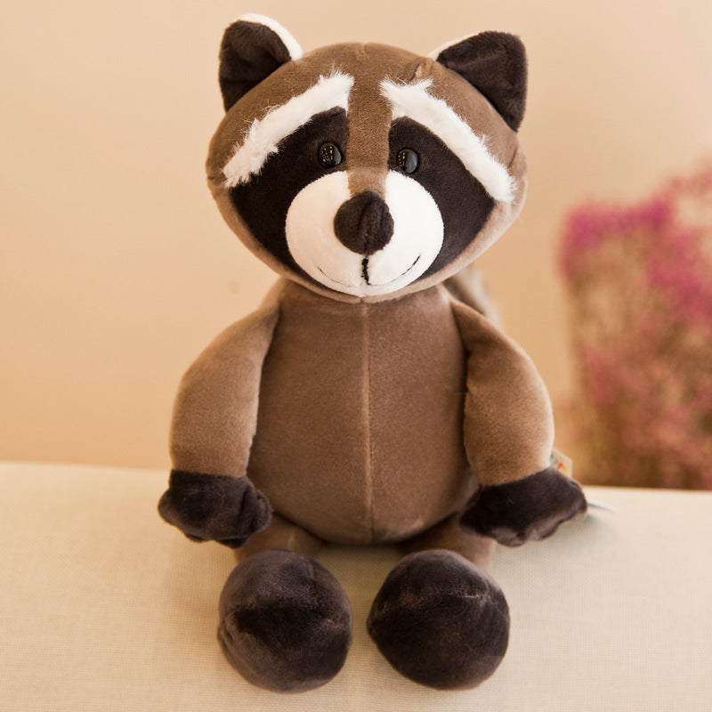 Plush raccoon toy on a light surface with a blurred background.