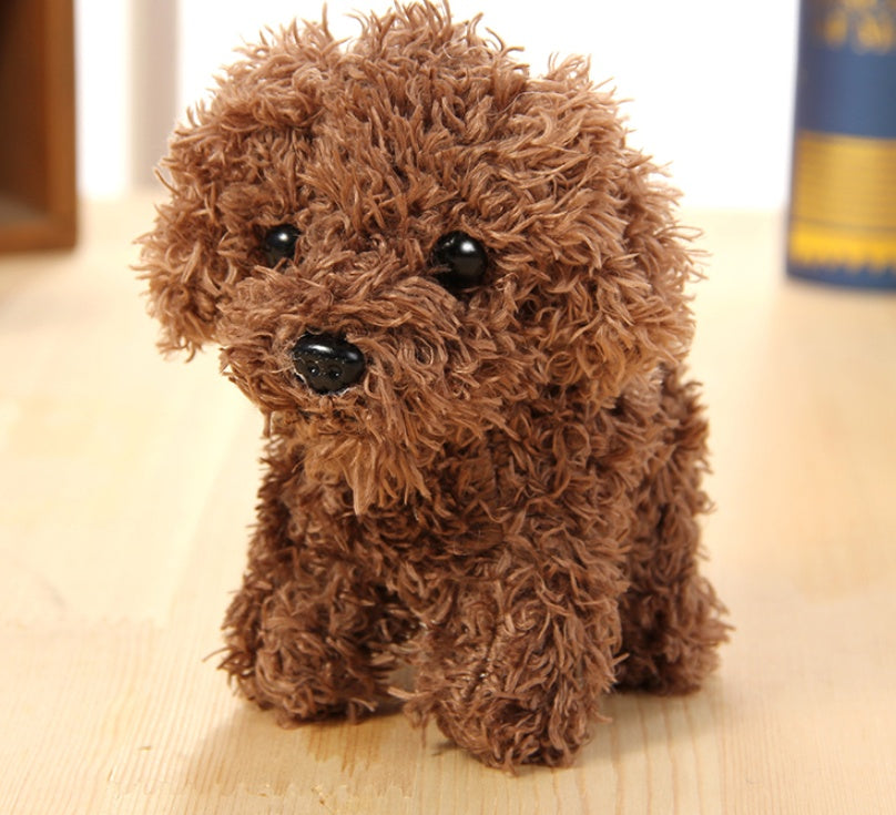Brown plush toy dog on a light wooden surface.