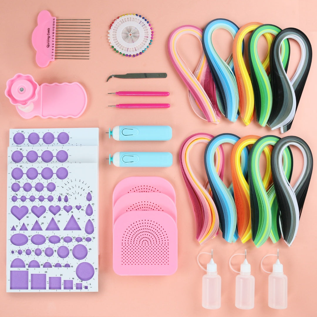 Assorted craft supplies including colorful paper strips, scissors, and a stencil on a pink background.