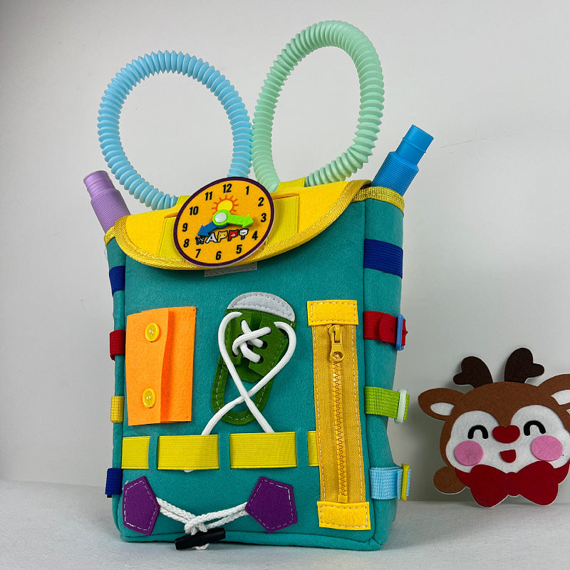 Colorful children's book with felt patches and a clock, featuring a small reindeer plush toy.