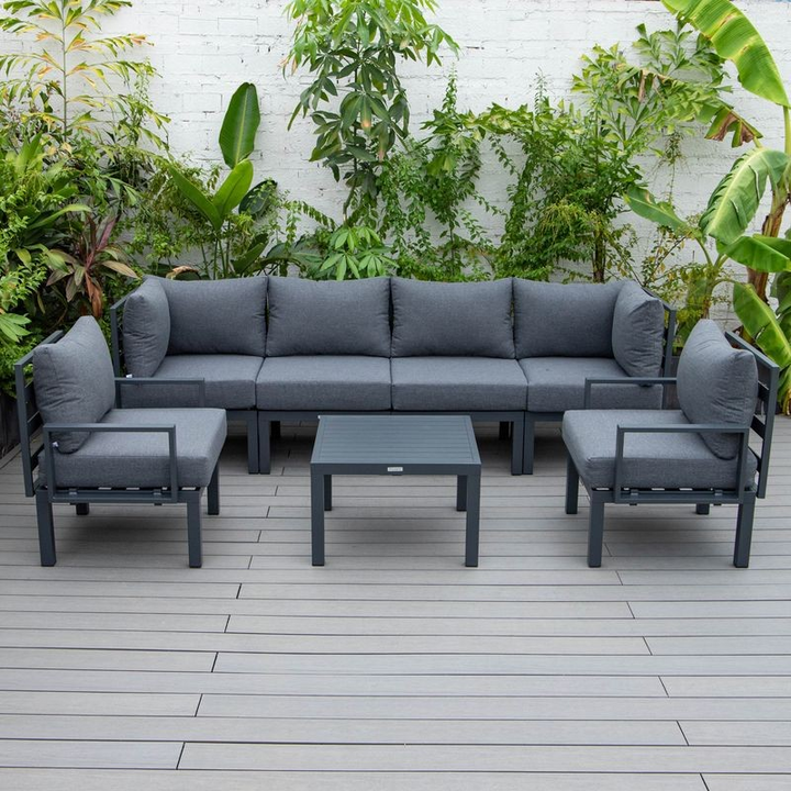 LeisureMod Chelsea 7-Piece Patio Sectional and Coffee Table Set Black Aluminum with Cushions Black Photo.