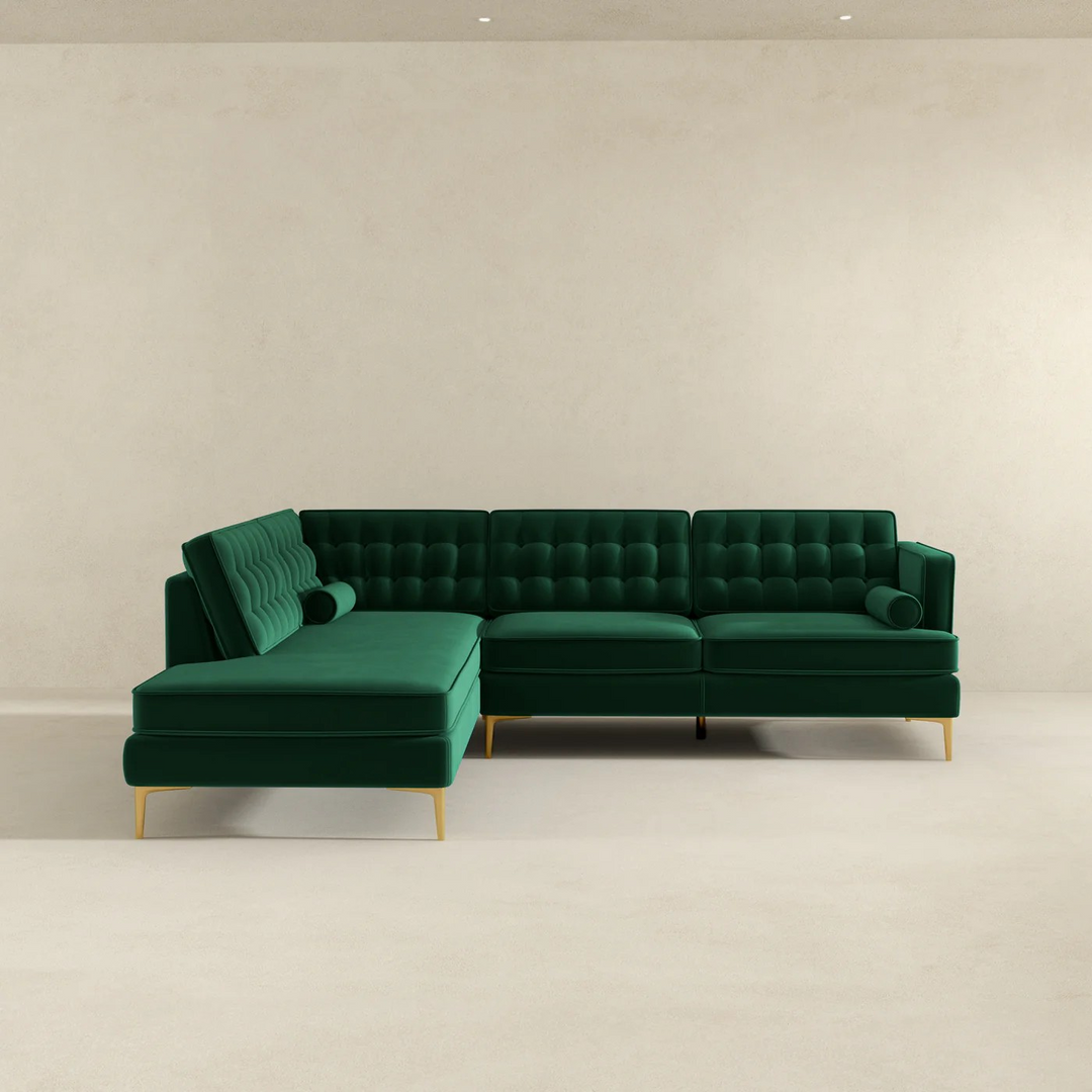 Green sectional sofa on a plain background.
