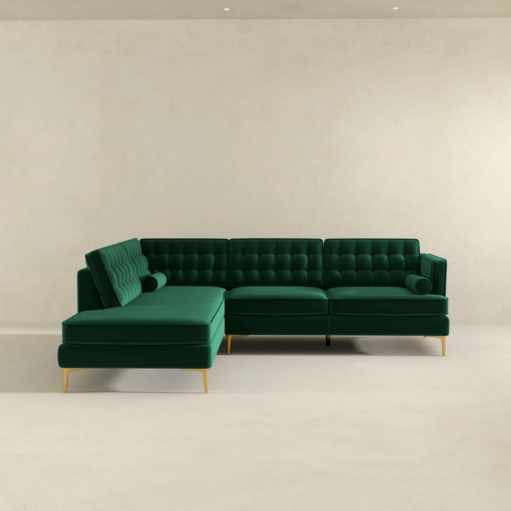 Green sectional sofa on a plain background.