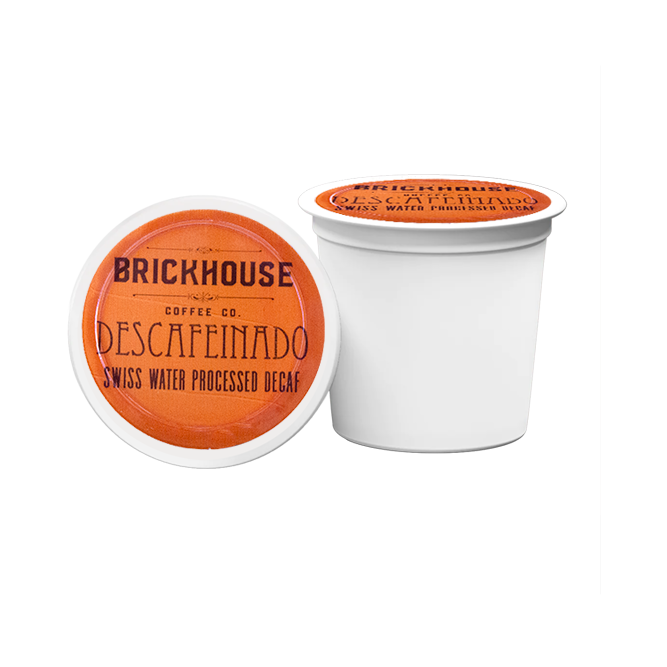 Two Brickhouse Coffee Co. Descafeinado Swiss Water Processed Decaf coffee pods on a white background.