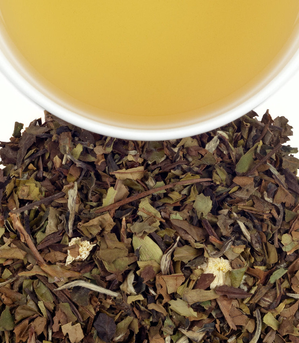 Tea leaves and a cup of tea on a white background.