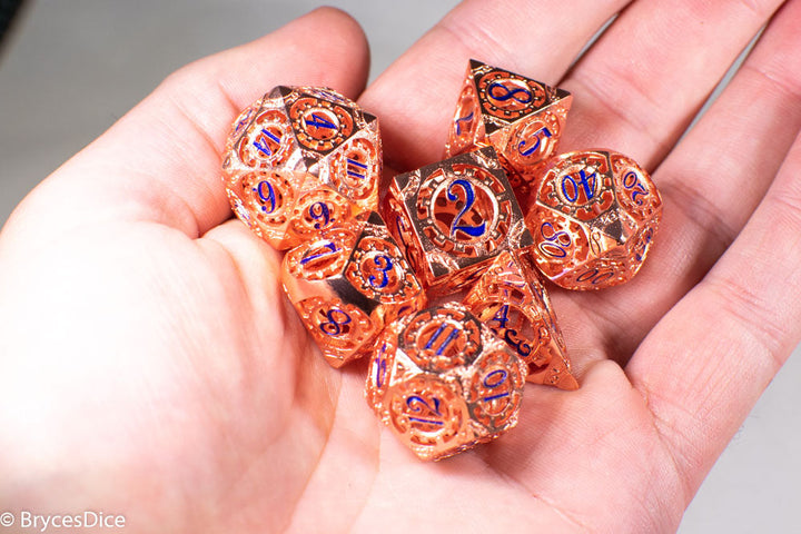 Rose Gold Metal Hollow Gear Dice with Blue Numbers 7-Dice Set