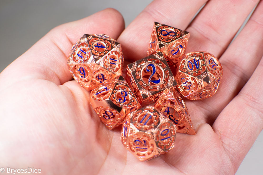 Rose Gold Metal Hollow Gear Dice with Blue Numbers 7-Dice Set