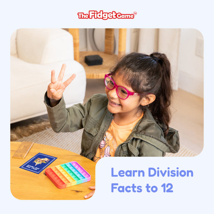 Child playing with educational game The Fidget Game to learn division facts, sitting on a couch.