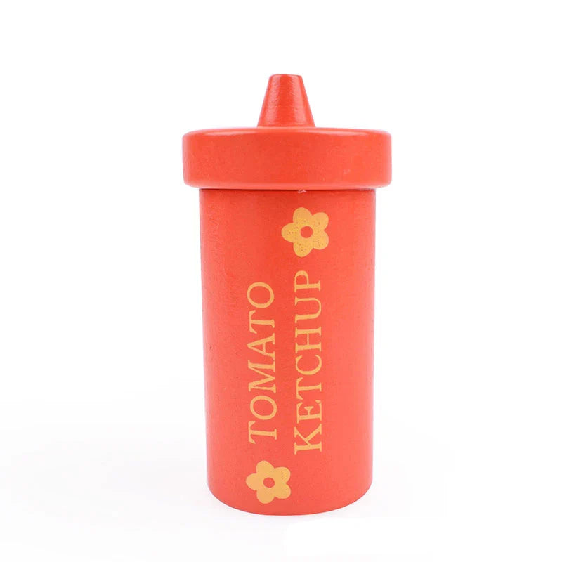 Red ketchup bottle with a yellow flower design on a white background.
