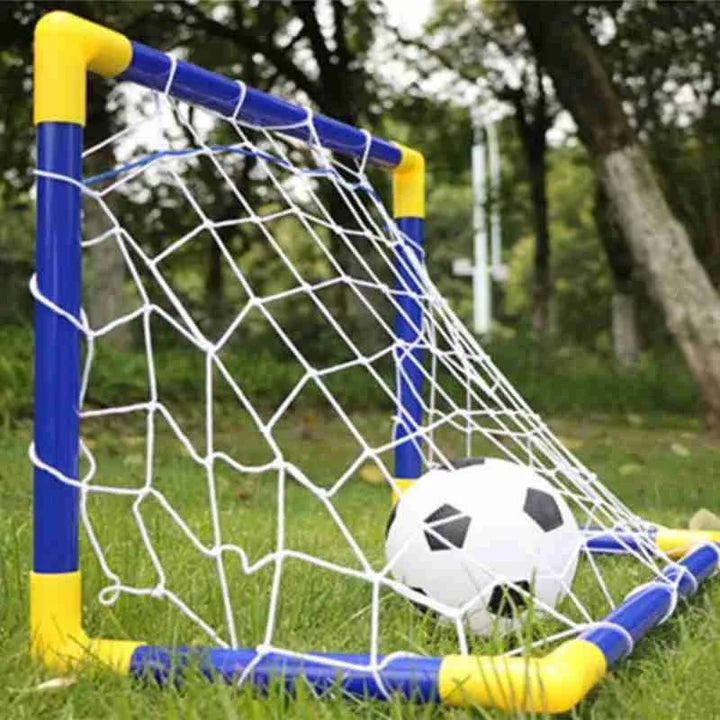 Children's soccer goal with a ball on a grassy field.