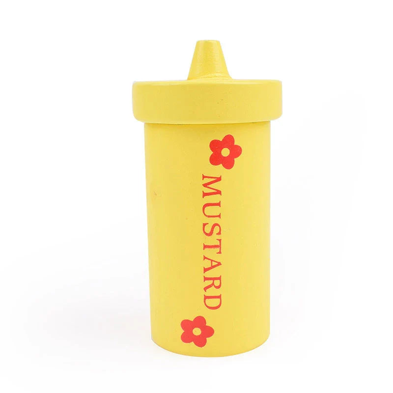 Yellow mustard container with red flowers and mustard text on a white background.