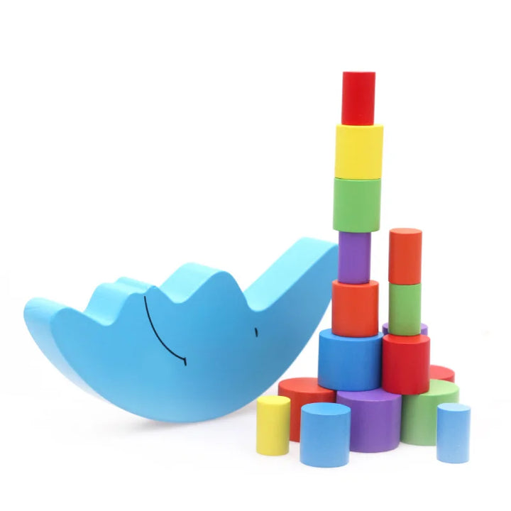 Colorful stackable blocks with a blue whale-shaped toy on a white background.