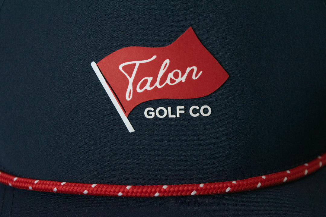 Blue Baseball Hat with Red Rope with Flag Logo Closeup.
