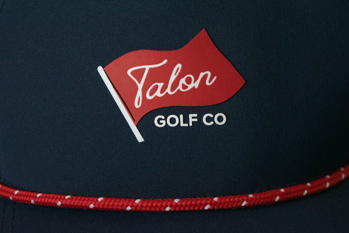 Blue Baseball Hat with Red Rope with Flag Logo Closeup.