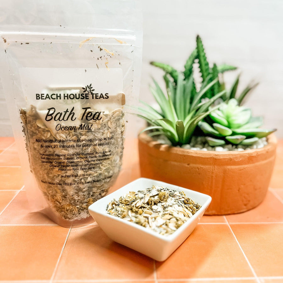Beach House Teas Bath Ocean Mist packaging with a bowl of tea leaves and a potted plant on a tiled surface.