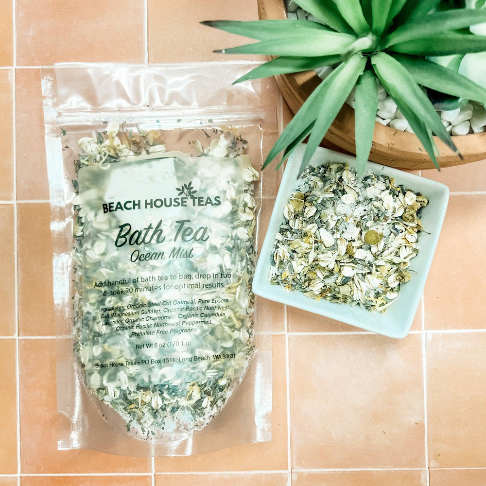 Beach House Teas Bath Tea Ocean Mist packaging on a tiled surface with a plant.